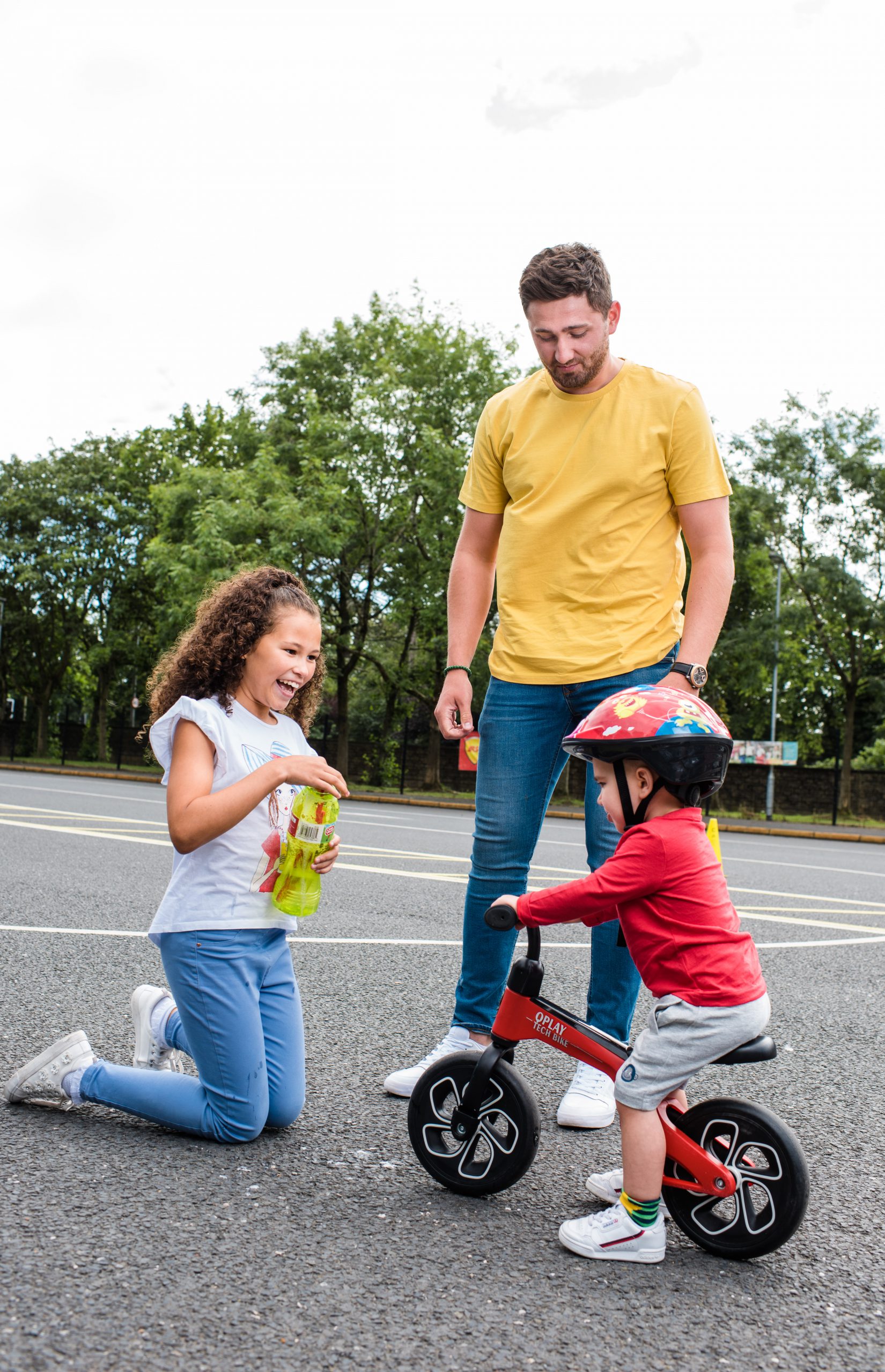 male foster carer and two kids playing