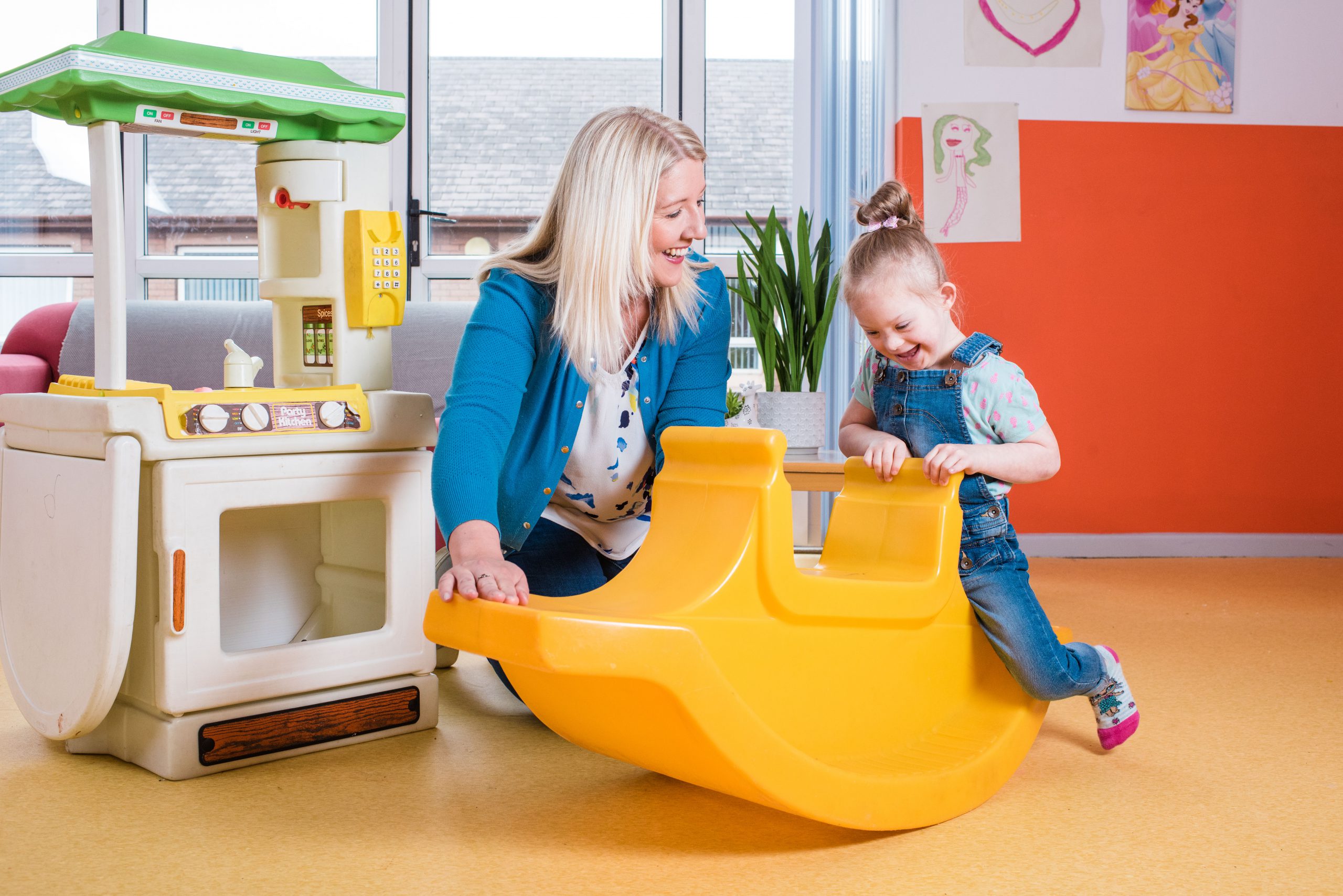 Female foster carer and child playing