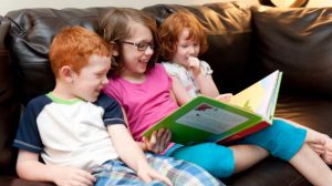 image of 3 siblings reading