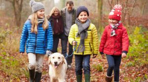 Family walking their dog in woods