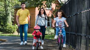 male and female couple with young children on bikes