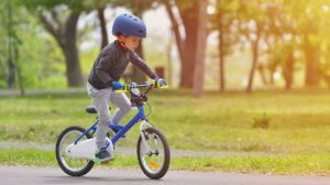 young boy on bike outside